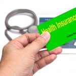 picture of a hand holding an insurance card