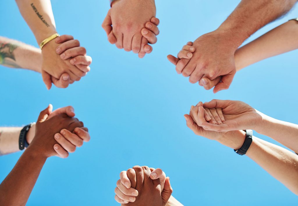 Cropped shot of a group of people holding hands
